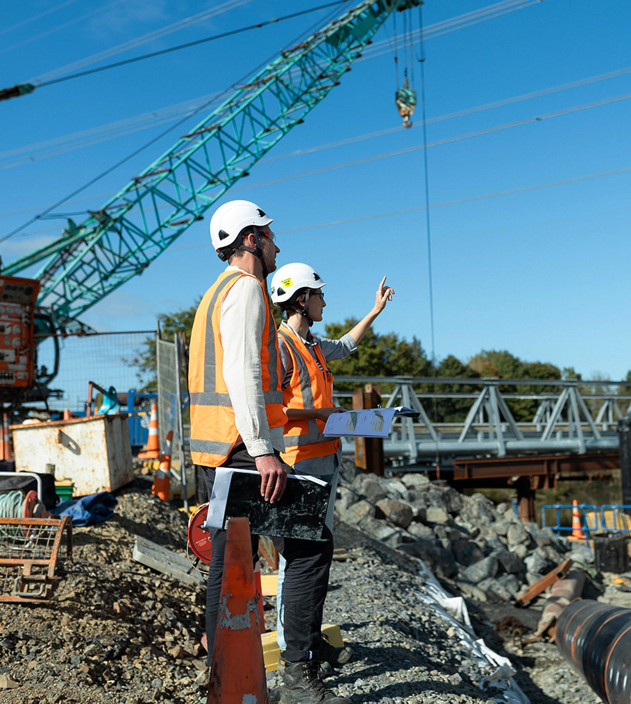 Construction Dewatering - Bridge Construction with consultants and a crane in the background - Earthtech Consulting